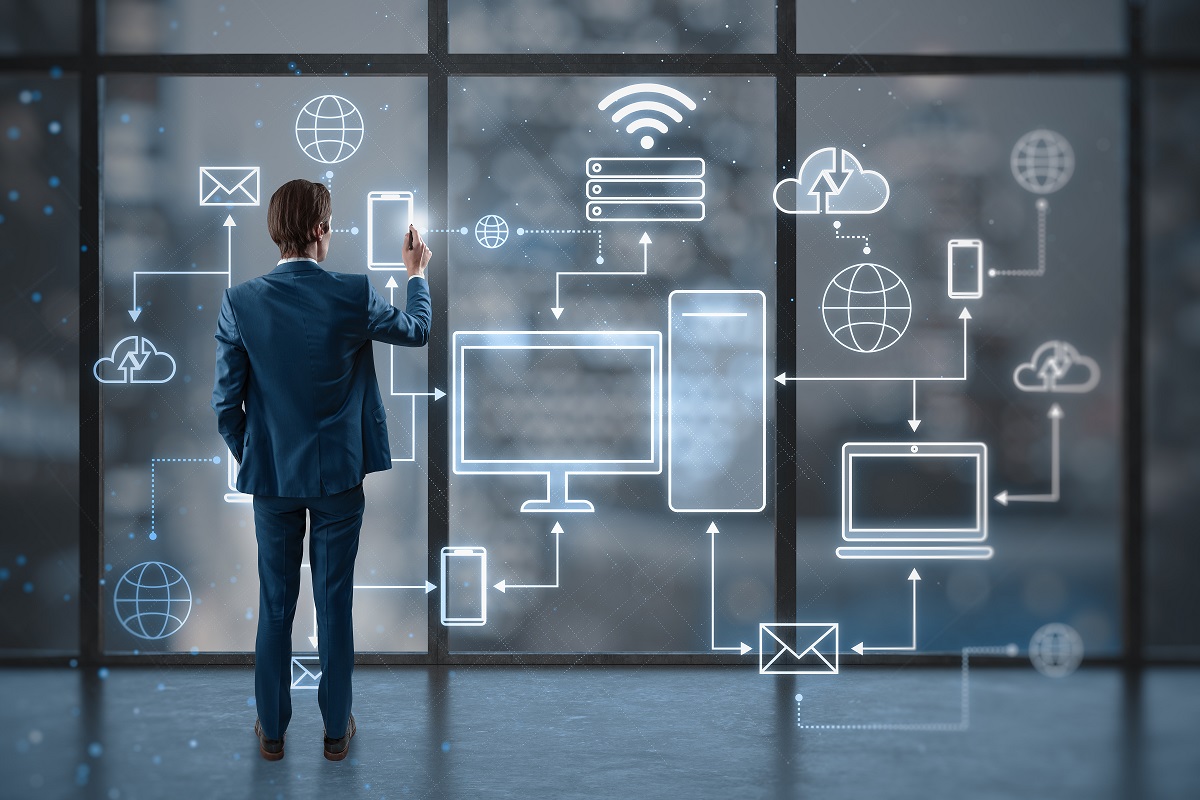 Cloud technologies and cloud computing concept with man back view working with devices connected to digital storage in a data center over the Internet on virtual wall screen on window background